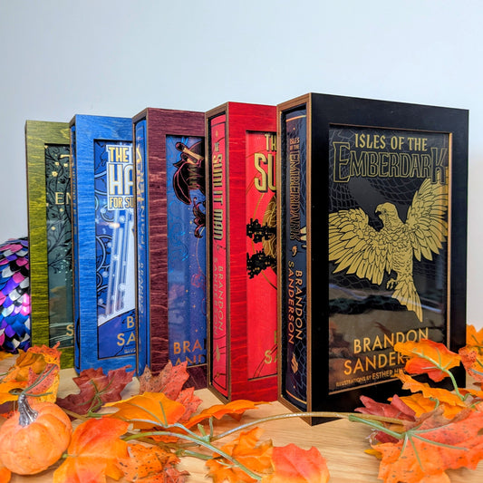 display cases for brandon sanderson's secret project novels, tress, frugal wizard, yumi, and sunlit man