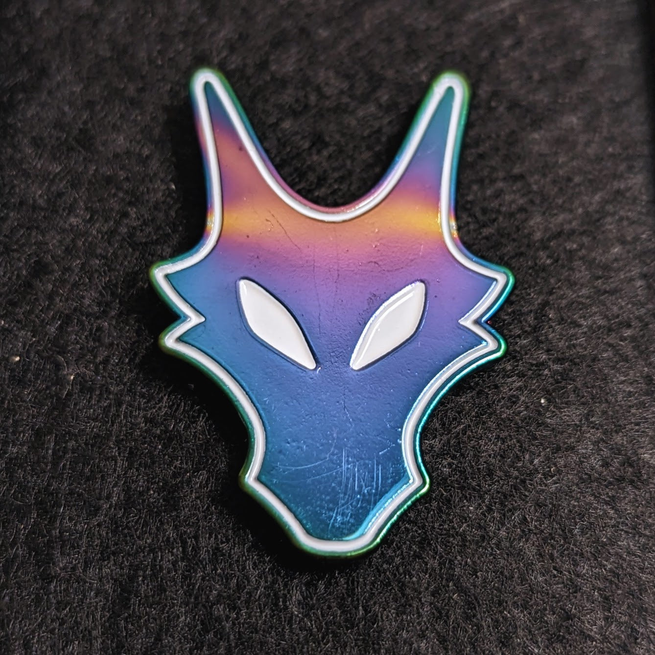 dragon woodshop logo pin in rainbow metal and soft white enamel fill