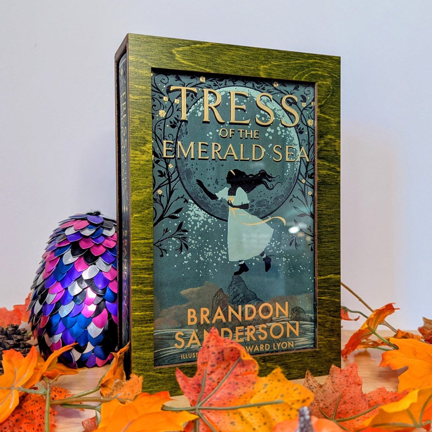 display cases for brandon sanderson's secret project novels, tress, frugal wizard, yumi, and sunlit man