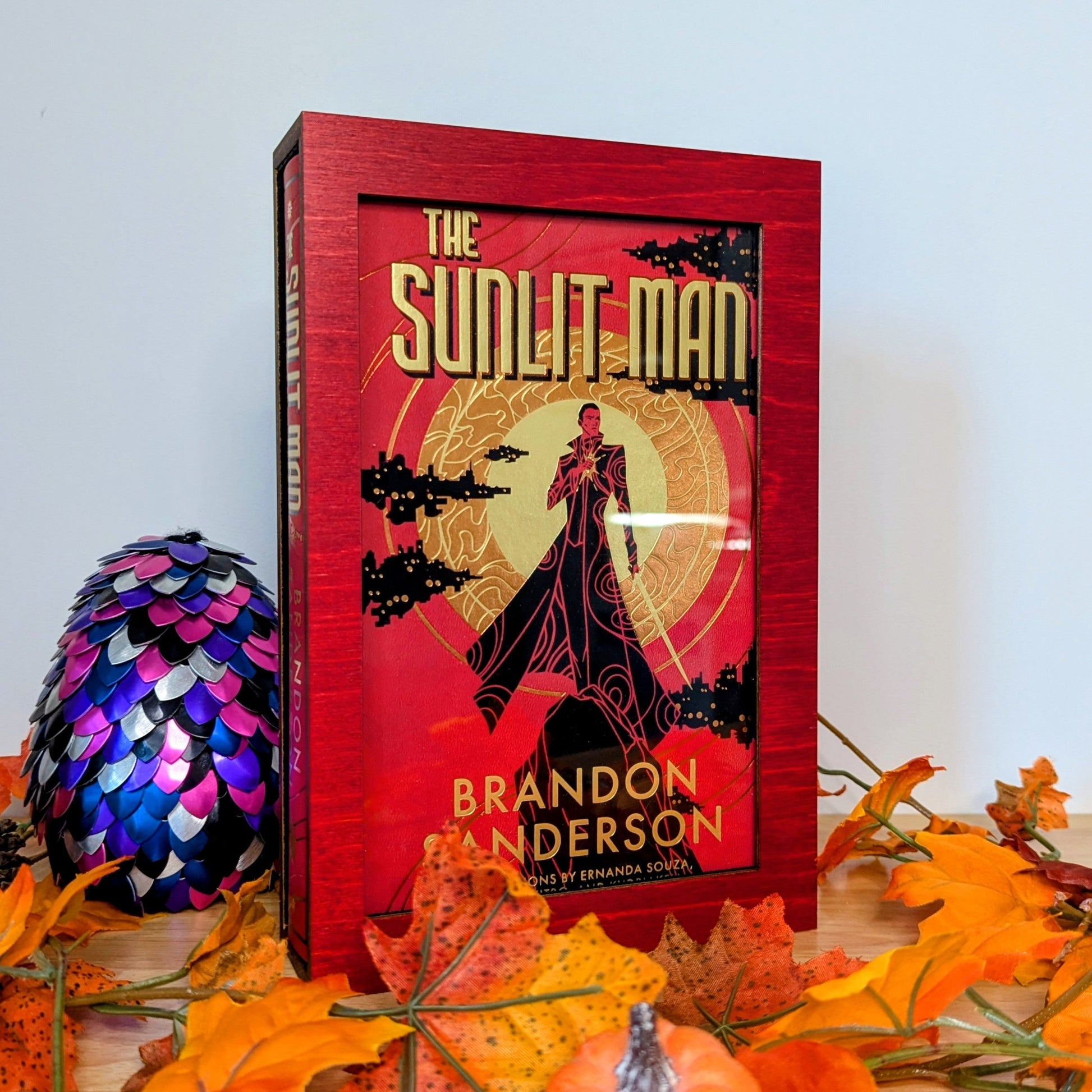 display cases for brandon sanderson's secret project novels, tress, frugal wizard, yumi, and sunlit man
